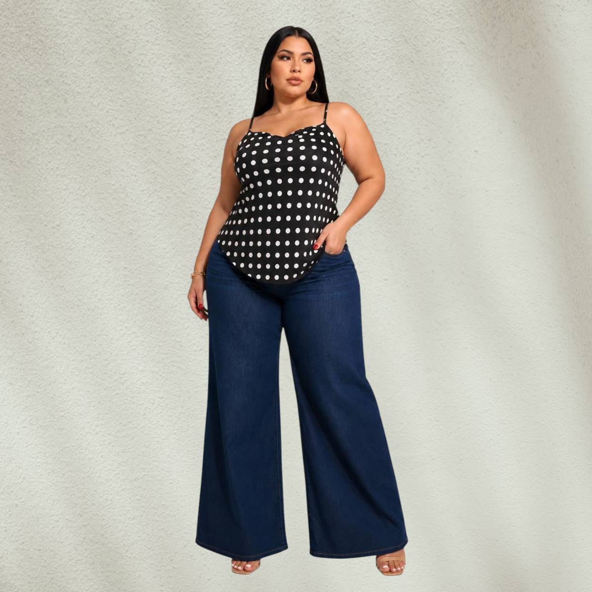 Purple Lola's Block plus size model wearing a black polka dot tank top with spaghetti straps and wide leg jeans.