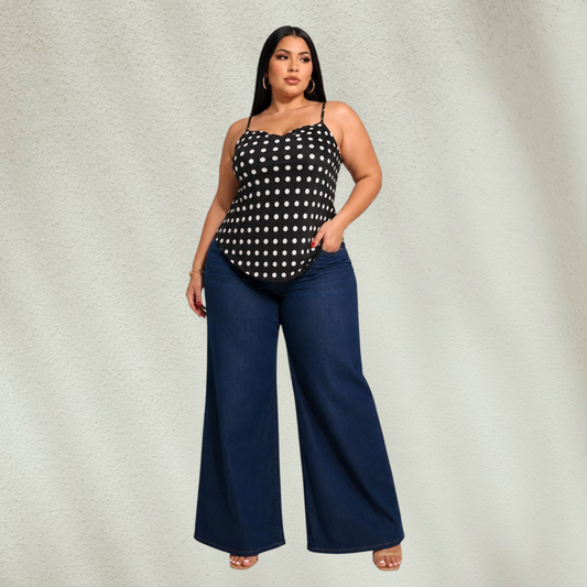 Purple Lola's Block plus size model wearing a black polka dot tank top with spaghetti straps and wide leg jeans.