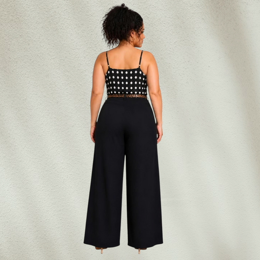 Purple Lola's Block black wide leg pants with an animal print belt, paired with a polka dot camisole on a model.